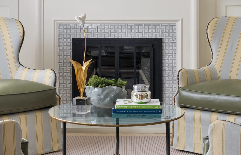 Arm chairs in front of tiled fireplace