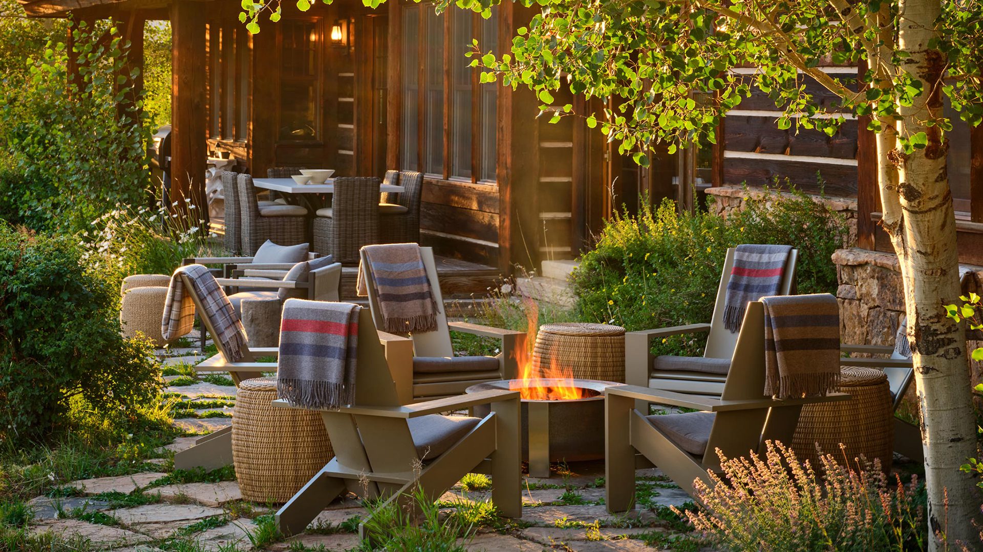 Cozy outdoor patio with fire pit and modern Adirondack chairs